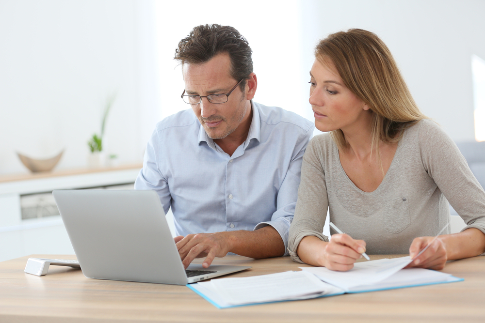 Couple-at-home-working-on-laptop-computer