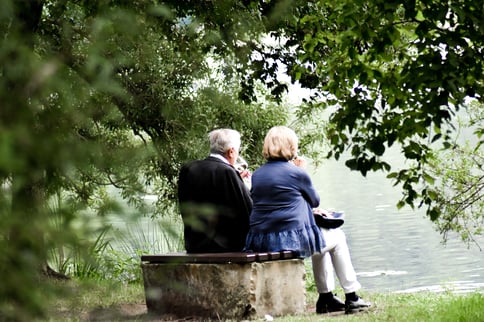 older-couple-sitting-by-pond