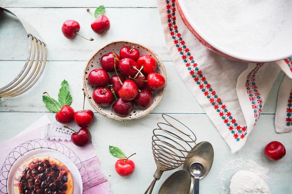 red cherries in a bowl on a table