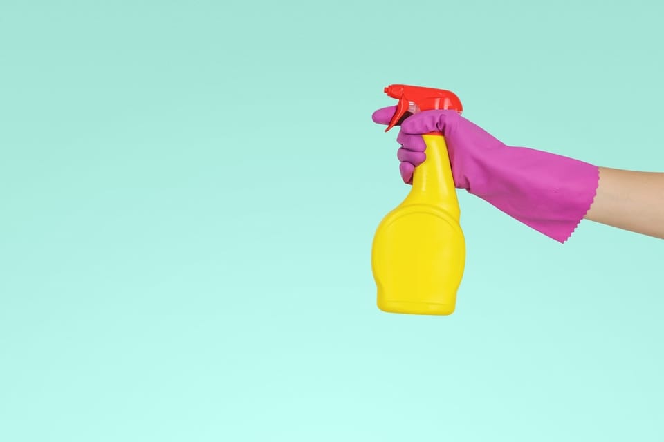 gloved-hand-holding-spray-bottle